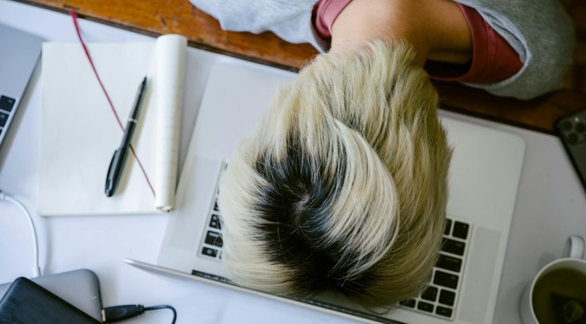 exhausted woman with head on keyboard