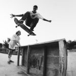 young active skater leaping high in park