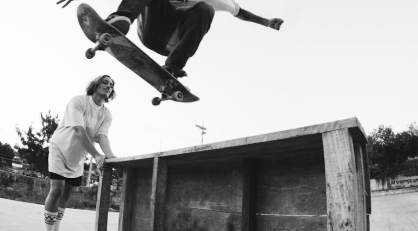 young active skater leaping high in park