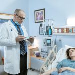 a physician in white coat checking up on his patient